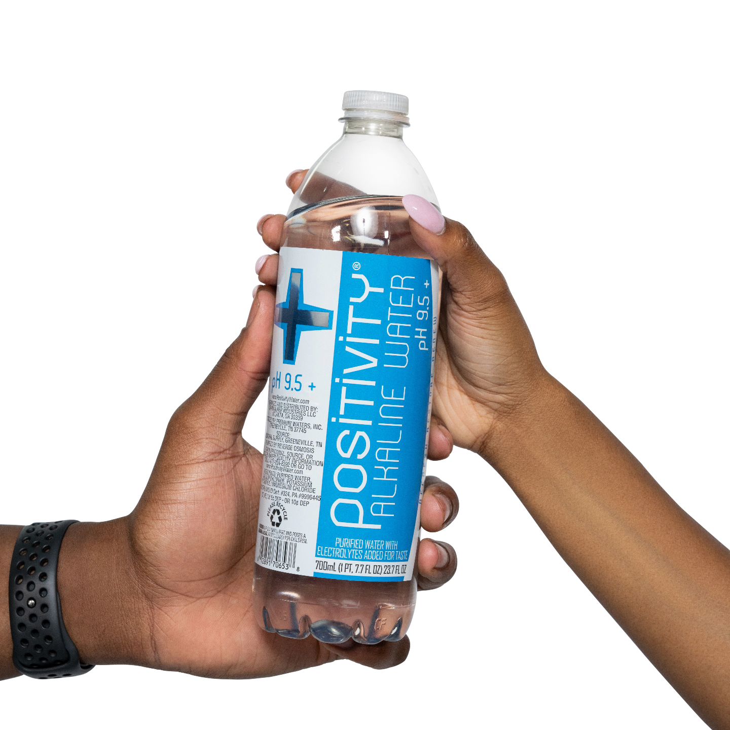 Two people passing a bottle of Positivity alkaline water to each other