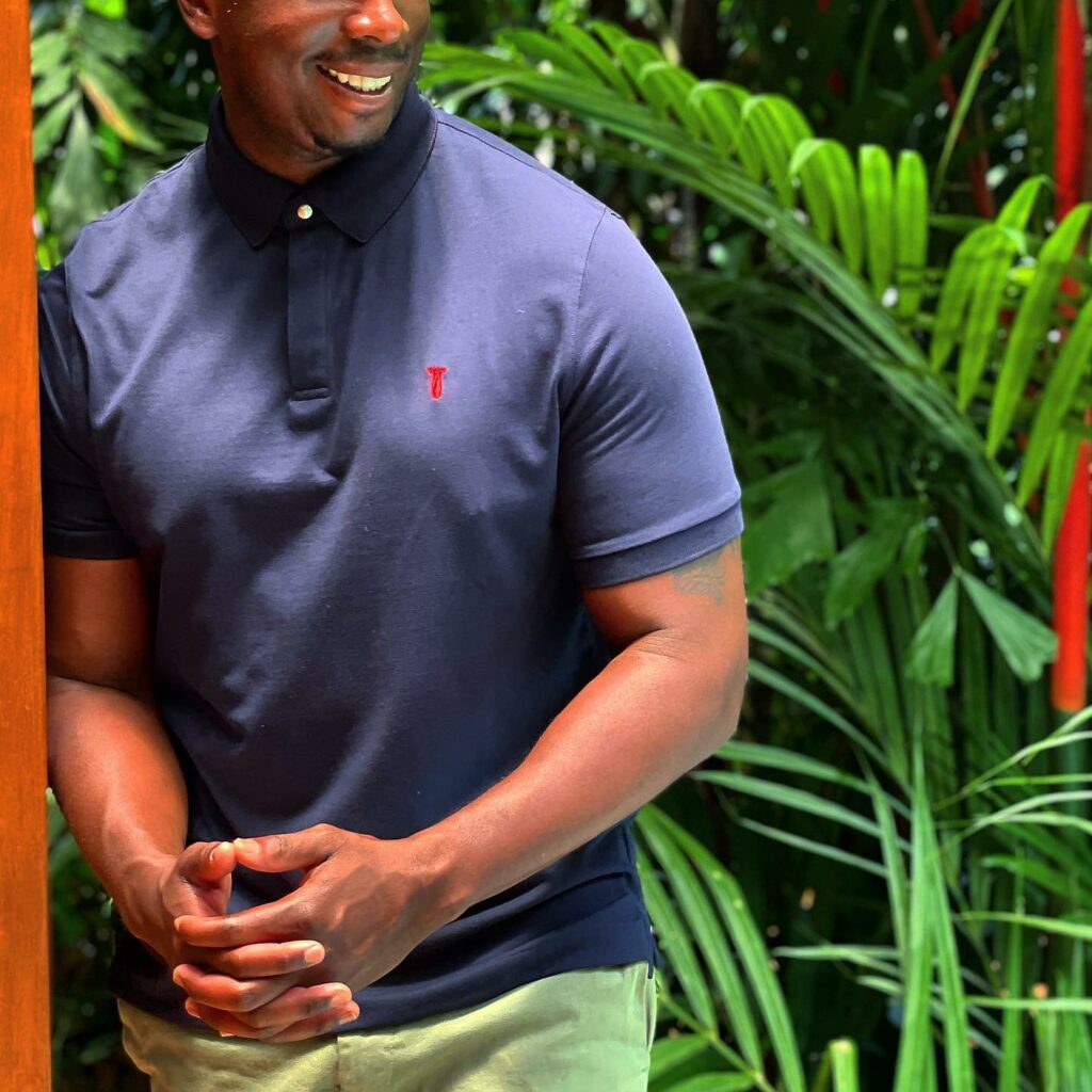 man wearing a blue baobab polo style shirt