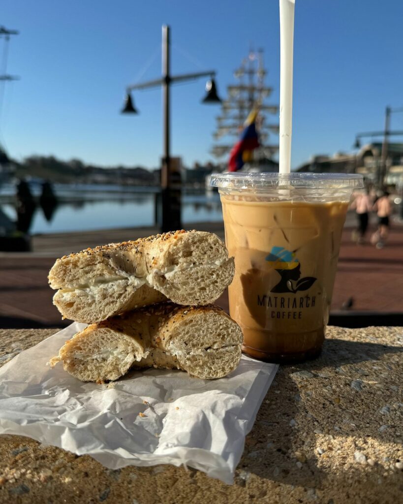 Iced Coffee and a bagel from Matriarch Coffee in front of the USS Constellation