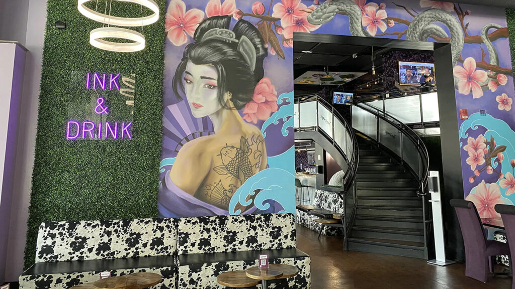 a Geisha mural on the entrance wall of Tattoos and Booz in Charlotte