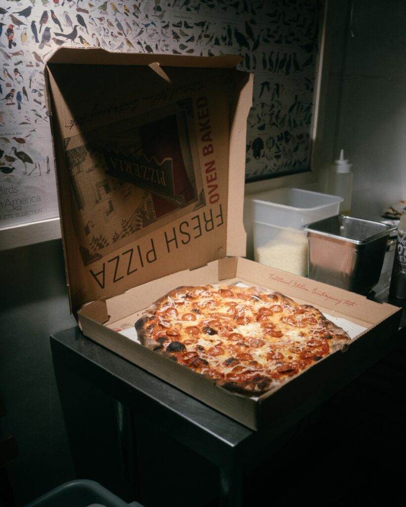 pepperoni pizza in a box on a counter from Bird Pizzeria