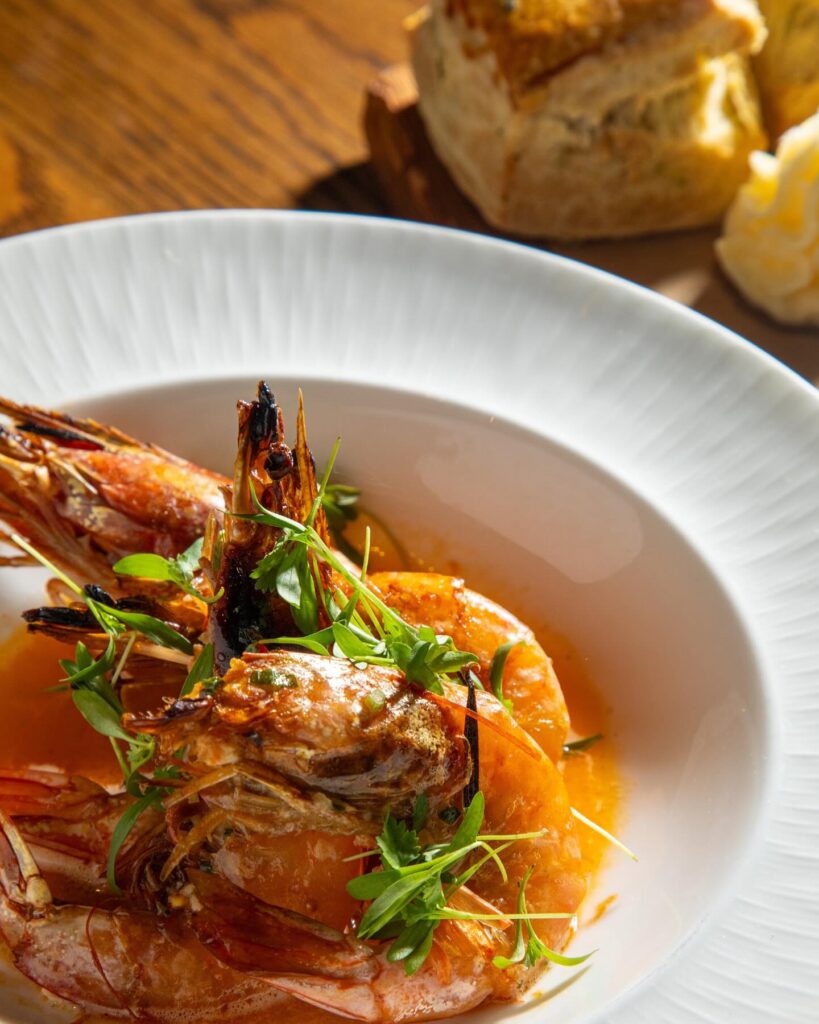 Compere Lapin broiled shrimp and spicy chili butter is best paired with our buttermilk biscuits