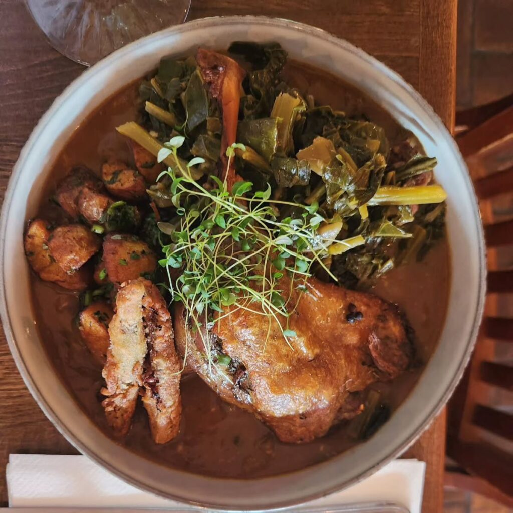 Duck Confit Gumbo - confit duck leg, confit potatoes, collard greens, Gumbo, fried okra from Rooted Rotisserie